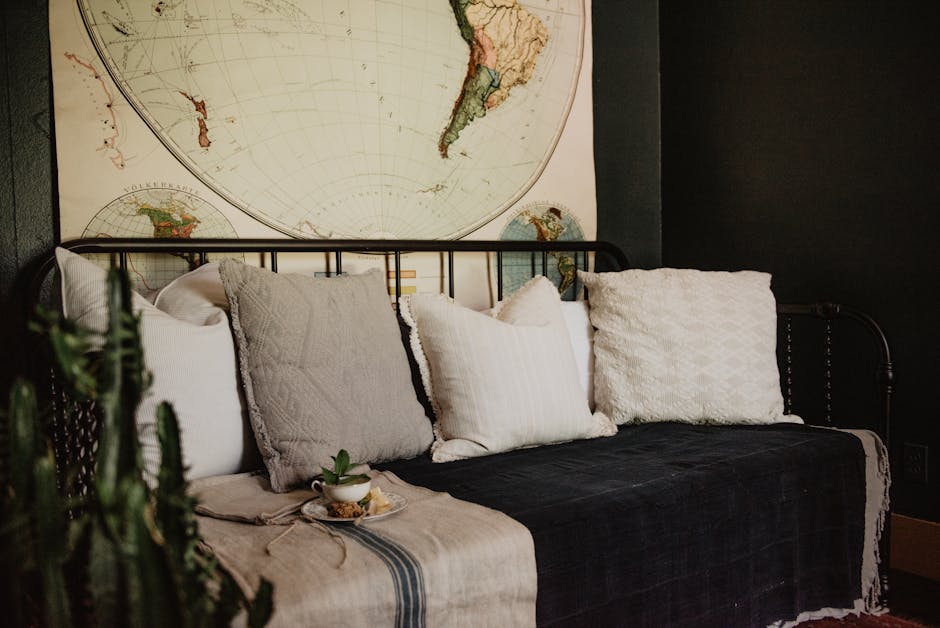 Modern home interior featuring a comfortable sofa with pillows and a vintage map backdrop for stylish relaxation.