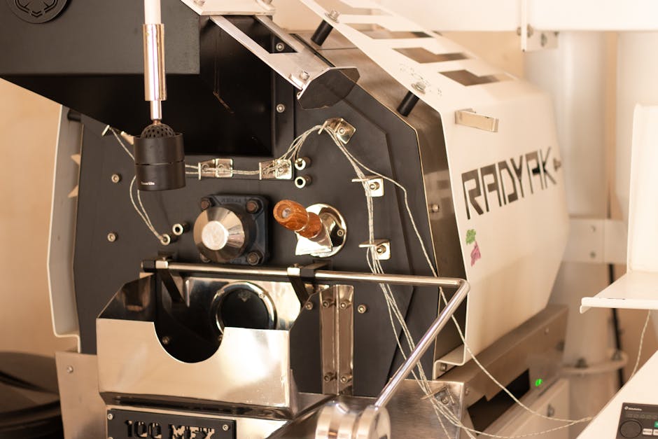 Detailed view of a modern coffee roaster machine in action, perfect for cafes.